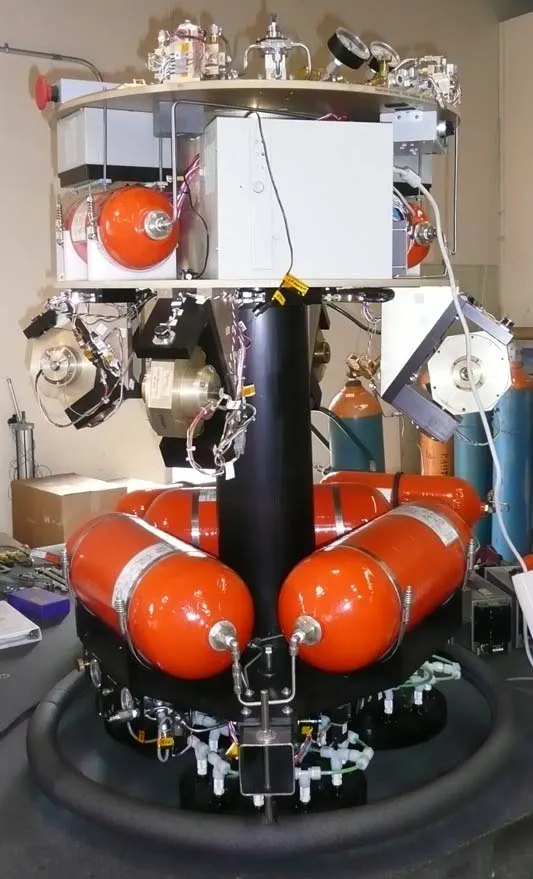 width:324px The ASTROS experimental platform, showing the central air-bearing column, VSCMG cluster, and compressed-gas tanks