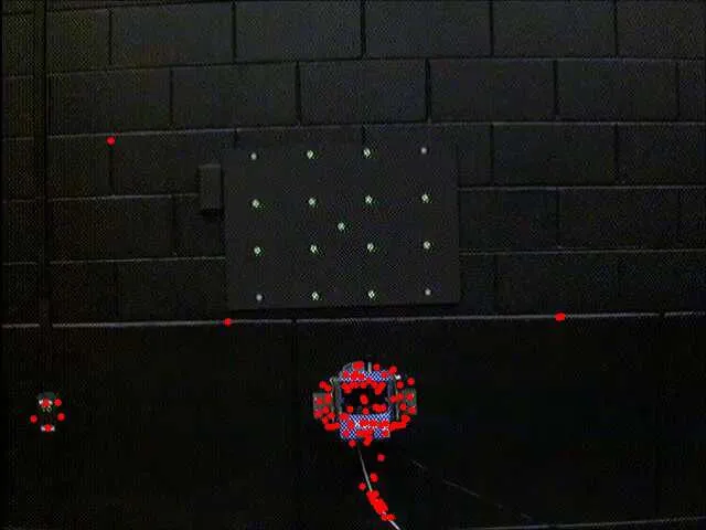 Feature detection on a laboratory target: detected corner and blob features marked across the scene